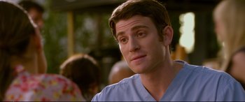 Movie still from “Friends with Benefits” (2011), directed by Will Gluck – A man that is wearing a blue shirt; Close Up shot, Over the shoulder angle