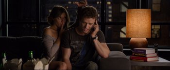 Movie still from “Friends with Benefits” (2011), directed by Will Gluck – A man talking on a cell phone next to a woman; Medium shot, Over the shoulder angle