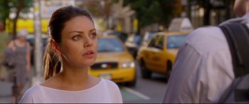Movie still from “Friends with Benefits” (2011), directed by Will Gluck – A woman standing on the side of a road near a busy street; Close Up shot, Over the shoulder angle