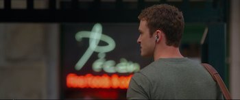 Movie still from “Friends with Benefits” (2011), directed by Will Gluck – A young man wearing a pair of ear buds; Close Up shot, Over the shoulder angle