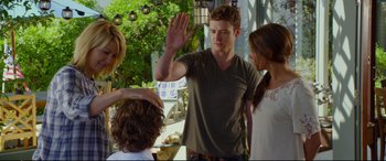 Movie still from “Friends with Benefits” (2011), directed by Will Gluck – A group of people standing next to each other on a patio; Medium shot, Over the shoulder angle