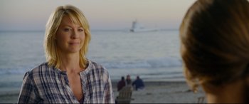 Movie still from “Friends with Benefits” (2011), directed by Will Gluck – A woman standing on the beach near the ocean; Medium shot, Over the shoulder angle