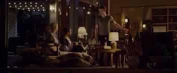 Movie still from “Friends with Benefits” (2011), directed by Will Gluck – A group of people sitting in a living room; Wide shot, Over the shoulder angle