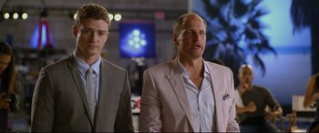 Movie still from “Friends with Benefits” (2011), directed by Will Gluck – A man in a suit and tie standing next to another man in a suit and tie; Close Up shot, Over the shoulder angle
