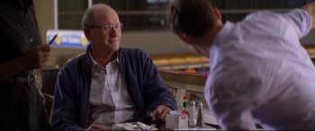 Movie still from “Friends with Benefits” (2011), directed by Will Gluck – A man sitting at a table talking to another man in front of him; Close Up shot, Over the shoulder angle