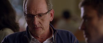 Movie still from “Friends with Benefits” (2011), directed by Will Gluck – An older man wearing glasses and a blue jacket; Close Up shot, Over the shoulder angle