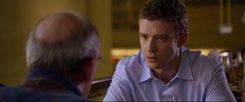 Movie still from “Friends with Benefits” (2011), directed by Will Gluck – A man in a blue dress shirt is talking to another man; Close Up shot, Over the shoulder angle