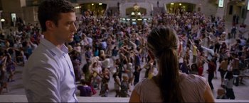 Movie still from “Friends with Benefits” (2011), directed by Will Gluck – A crowd of people gathered in a large room; Wide shot, Over the shoulder angle
