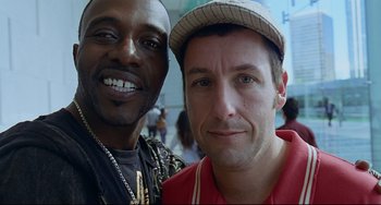 Movie still from “Funny People” (2009), directed by Judd Apatow – Two men posing for a picture in a crowd; Close Up shot, Low angle