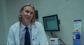 Movie still from “Funny People” (2009), directed by Judd Apatow – A doctor sitting in front of a computer monitor; Close Up shot, Over the shoulder angle