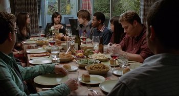Movie still from “Funny People” (2009), directed by Judd Apatow – A group of people sitting around a table eating food; Medium shot, High angle