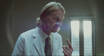 Movie still from “Funny People” (2009), directed by Judd Apatow – A man in a white lab coat and a tie; Close Up shot, Low angle