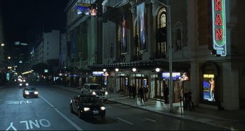 Movie still from “Funny People” (2009), directed by Judd Apatow – A car driving down a street next to a building; Extreme Wide shot, High angle