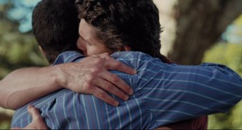 Movie still from “Funny People” (2009), directed by Judd Apatow – Two people hugging each other in a room; Close Up shot, Over the shoulder angle