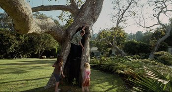 Movie still from “Funny People” (2009), directed by Judd Apatow – A man and two children climbing a tree; Wide shot, Low angle
