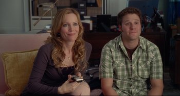 Movie still from “Funny People” (2009), directed by Judd Apatow – A woman and a man are sitting on a couch; Medium shot, Over the shoulder angle