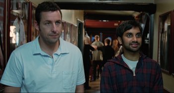 Movie still from “Funny People” (2009), directed by Judd Apatow – Two men standing next to each other in front of a crowd of onlookers; Medium shot, High angle