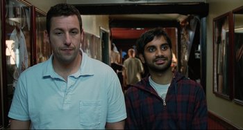 Movie still from “Funny People” (2009), directed by Judd Apatow – Two men standing next to each other in front of a crowd; Medium shot, High angle
