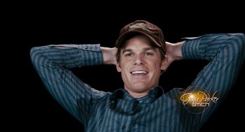 Movie still from “Gamer” (2009), directed by Mark Neveldine – A man in a striped shirt wearing a hat and smiling; Close Up shot, High angle