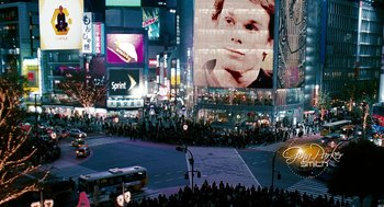 Movie still from “Gamer” (2009), directed by Mark Neveldine – A crowd of people standing on the side of a street; Extreme Wide shot, High angle