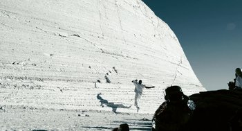 Movie still from “Gamer” (2009), directed by Mark Neveldine – A person is snowboarding down a snowy slope; Extreme Wide shot, Low angle