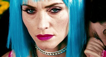 Movie still from “Gamer” (2009), directed by Mark Neveldine – A person with blue hair; Close Up shot, Low angle