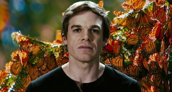 Movie still from “Gamer” (2009), directed by Mark Neveldine – A person wearing a black shirt near a bunch of butterflies; Close Up shot, Low angle