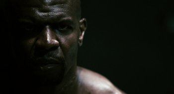 Movie still from “Gamer” (2009), directed by Mark Neveldine – A man's face in the dark; Extreme Close Up shot, Over the shoulder angle