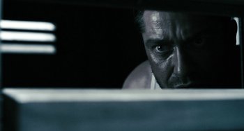 Movie still from “Gamer” (2009), directed by Mark Neveldine – A person looking at the camera; Close Up shot, Low angle