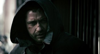Movie still from “Gamer” (2009), directed by Mark Neveldine – A person wearing a hooded jacket; Close Up shot, Low angle