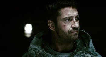 Movie still from “Gamer” (2009), directed by Mark Neveldine – A person wearing a jacket; Close Up shot, Over the shoulder angle