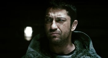 Movie still from “Gamer” (2009), directed by Mark Neveldine – A person wearing a jacket; Close Up shot, Over the shoulder angle