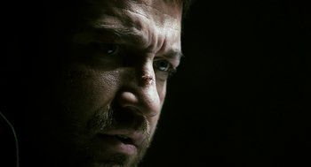 Movie still from “Gamer” (2009), directed by Mark Neveldine – A man's face in the dark; Extreme Close Up shot, Low angle