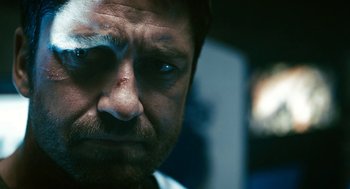 Movie still from “Gamer” (2009), directed by Mark Neveldine – A man's face with blue eyes; Close Up shot, Low angle