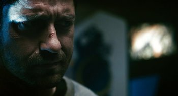 Movie still from “Gamer” (2009), directed by Mark Neveldine – A man's face with a cigarette in his mouth; Close Up shot, Over the shoulder angle