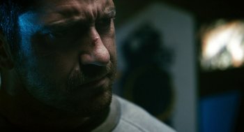 Movie still from “Gamer” (2009), directed by Mark Neveldine – A man's face and nose; Close Up shot, Over the shoulder angle