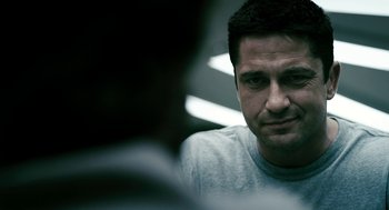 Movie still from “Gamer” (2009), directed by Mark Neveldine – A person looking at the camera; Close Up shot, Over the shoulder angle