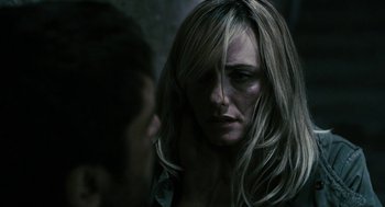 Movie still from “Gamer” (2009), directed by Mark Neveldine – A person with long blonde hair; Close Up shot, Over the shoulder angle