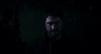 Movie still from “Gamer” (2009), directed by Mark Neveldine – A man in a black jacket is looking at the camera; Close Up shot, Low angle