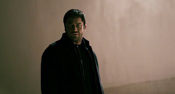 Movie still from “Gamer” (2009), directed by Mark Neveldine – A person wearing a black jacket; Medium shot, Over the shoulder angle