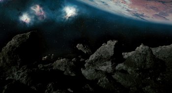 Movie still from “Gamer” (2009), directed by Mark Neveldine – An image of an asteroid in the space; Extreme Wide shot, Overhead angle