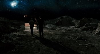 Movie still from “Gamer” (2009), directed by Mark Neveldine – Two men are standing on the side of the moon at night; Extreme Wide shot, High angle