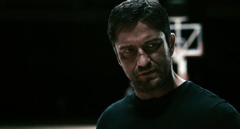 Movie still from “Gamer” (2009), directed by Mark Neveldine – A person wearing a black t - shirt; Close Up shot, Over the shoulder angle