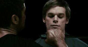 Movie still from “Gamer” (2009), directed by Mark Neveldine – A man with his hands on his face and another man with his hands on his neck; Close Up shot, Over the shoulder angle