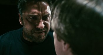 Movie still from “Gamer” (2009), directed by Mark Neveldine – A person looking at another person; Close Up shot, Over the shoulder angle