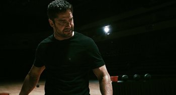 Movie still from “Gamer” (2009), directed by Mark Neveldine – A person wearing a black t - shirt; Close Up shot, Low angle