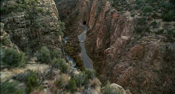 Movie still from “Gamer” (2009), directed by Mark Neveldine – A road going through the middle of a canyon; Extreme Wide shot, High angle