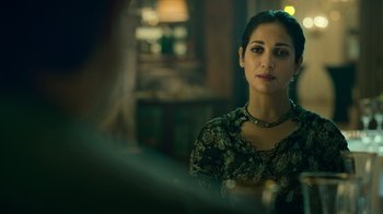 Movie still from “Ganglands” (2021), created by Julien Leclercq – A woman sitting at a table in front of a mirror; Close Up shot, Over the shoulder angle