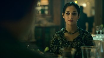 Movie still from “Ganglands” (2021), created by Julien Leclercq – A woman sitting at a table in front of a mirror; Close Up shot, Over the shoulder angle