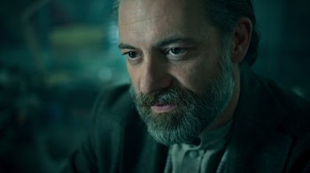 Movie still from “Ganglands” (2021), created by Julien Leclercq – A person with a beard; Close Up shot, Low angle